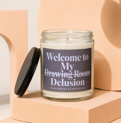 Candle with label saying "Welcome to My Drawing Room Delusion"