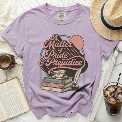 Lavender t-shirt with "A Matter of Pride & Prejudice" graphic and books.