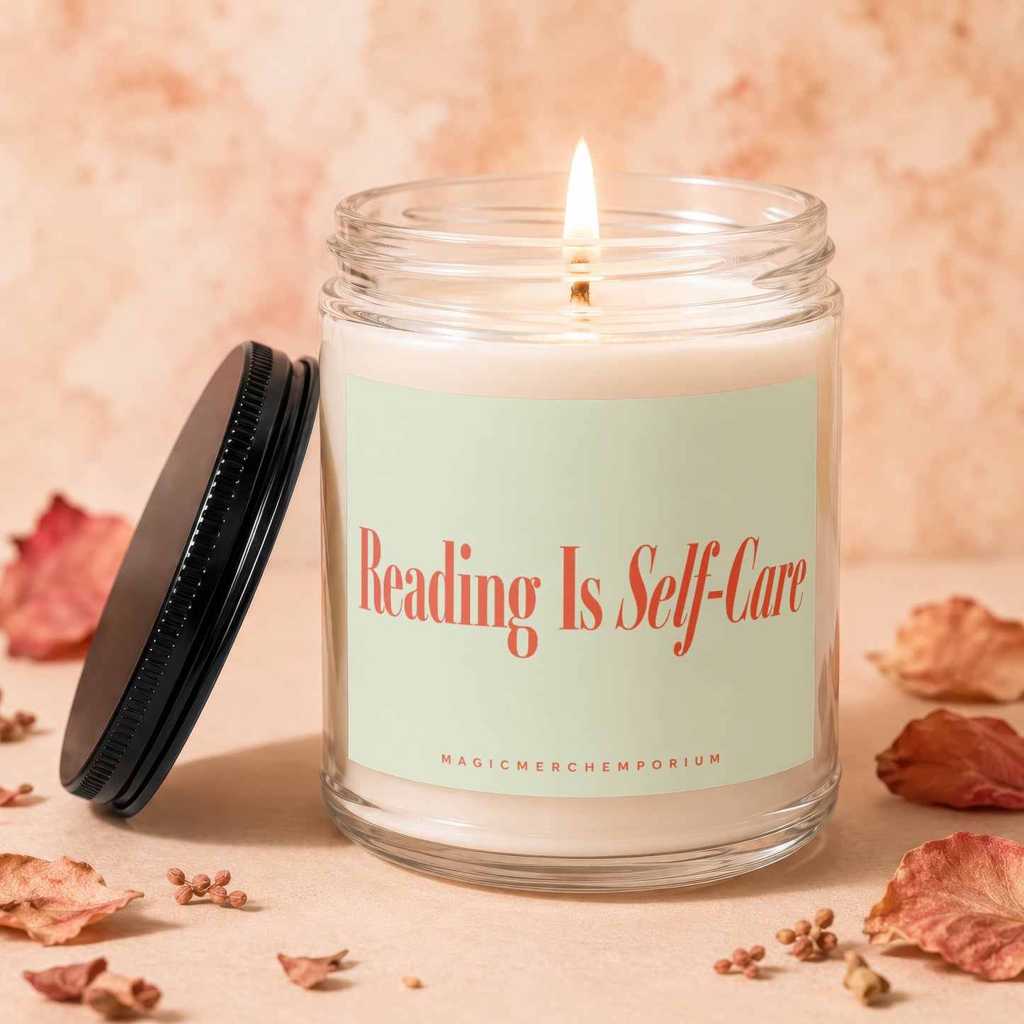 Glass candle with lit wick and "Reading Is Self-Care" label.