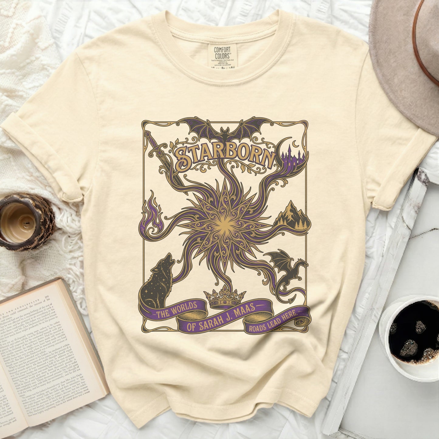 Cream t-shirt with "Starborn" text and a purple celestial design.