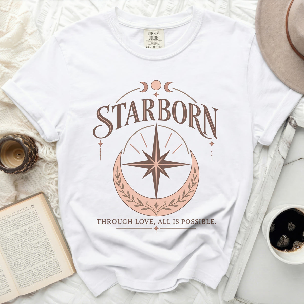 White Comfort Colors t-shirt with "STARBORN" and "THROUGH LOVE, ALL IS POSSIBLE." text.