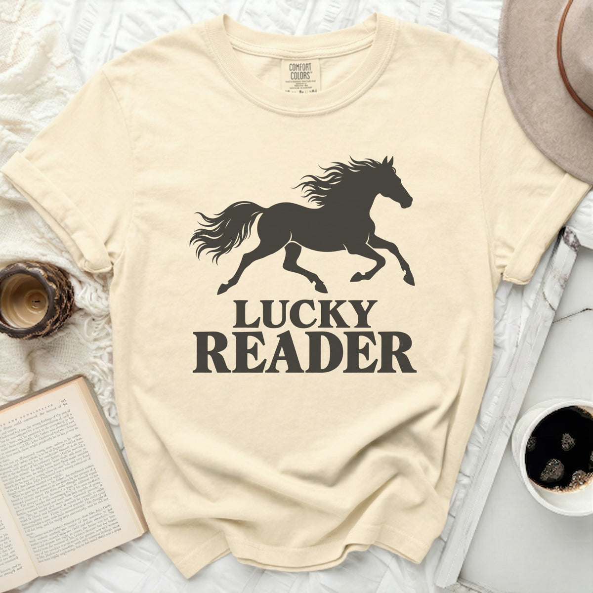 Cream t-shirt with black silhouette of running horse and text "LUCKY READER".