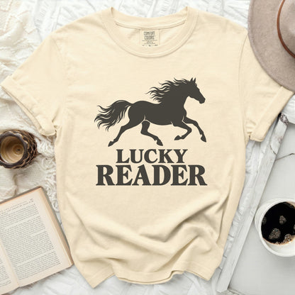 Cream t-shirt with black silhouette of running horse and text "LUCKY READER".