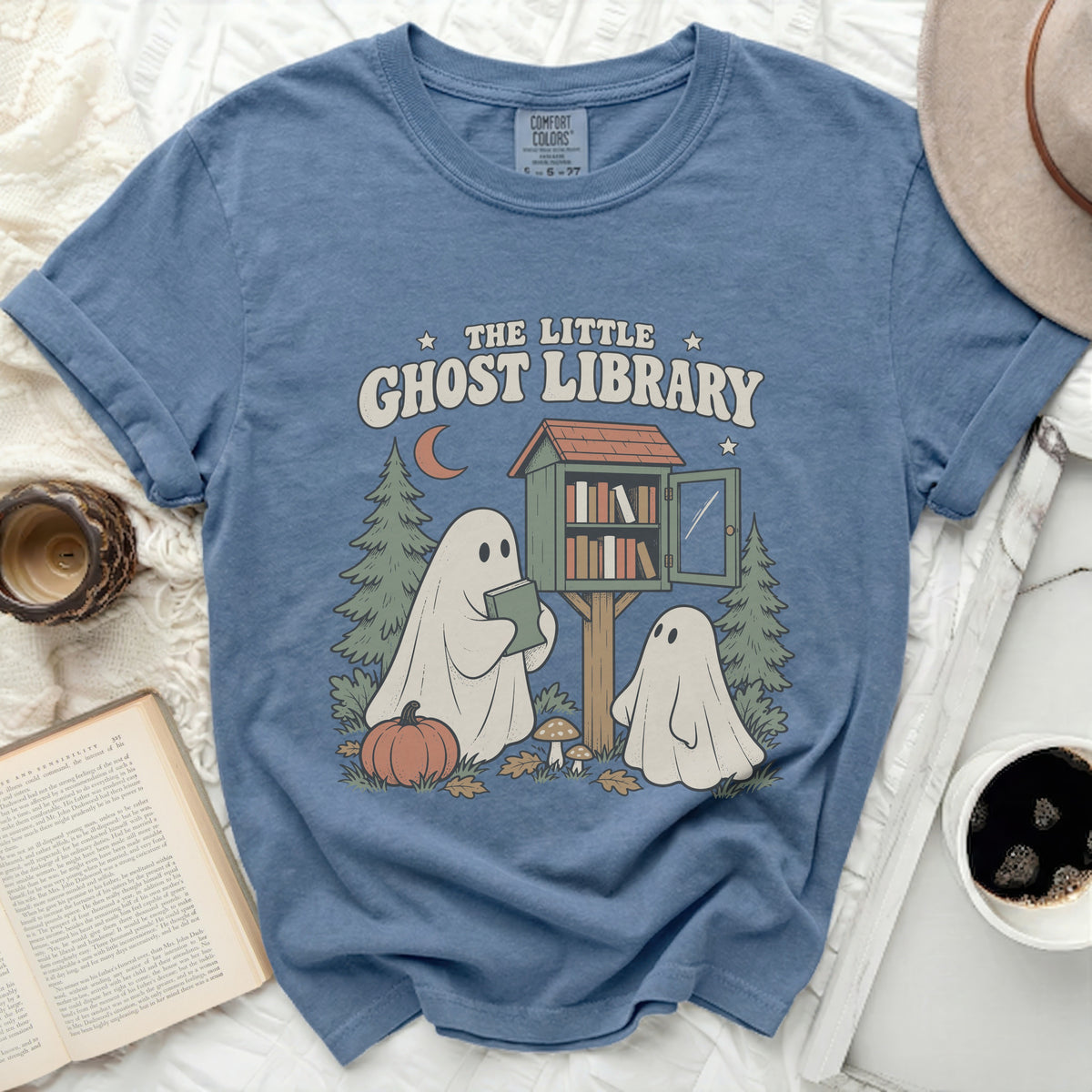 T-shirt graphic with ghosts at a little ghost library, reading books.