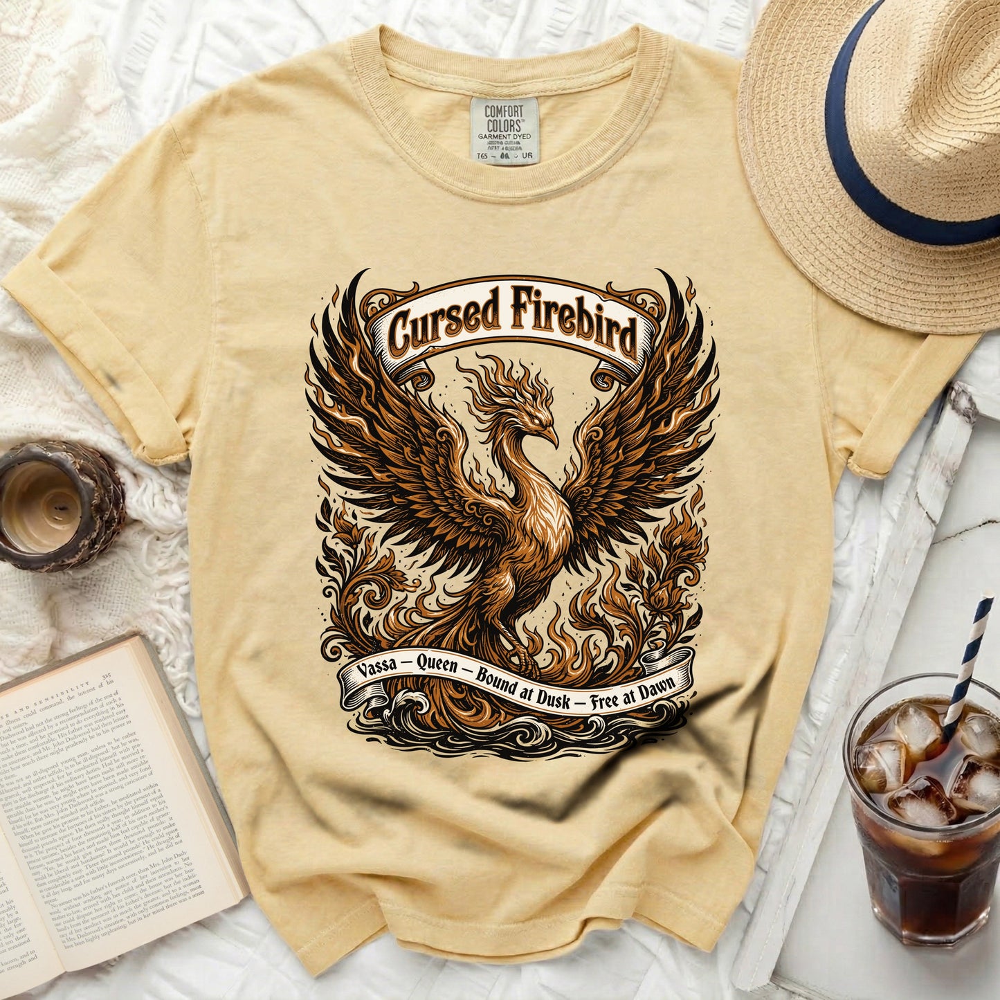 Yellow t-shirt with a phoenix graphic and text "Cursed Firebird".