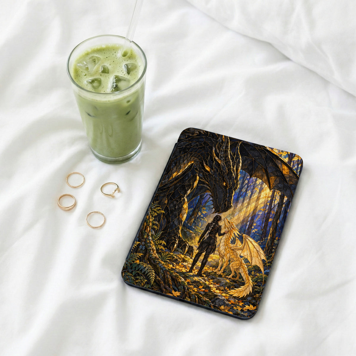 E-reader case featuring a dark dragon, woman, and golden dragon in a forest.