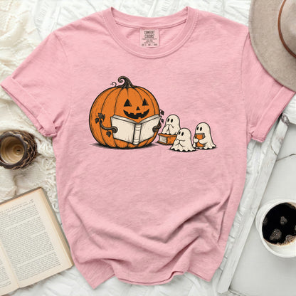 Pink t-shirt with a graphic of a pumpkin reading to ghosts.