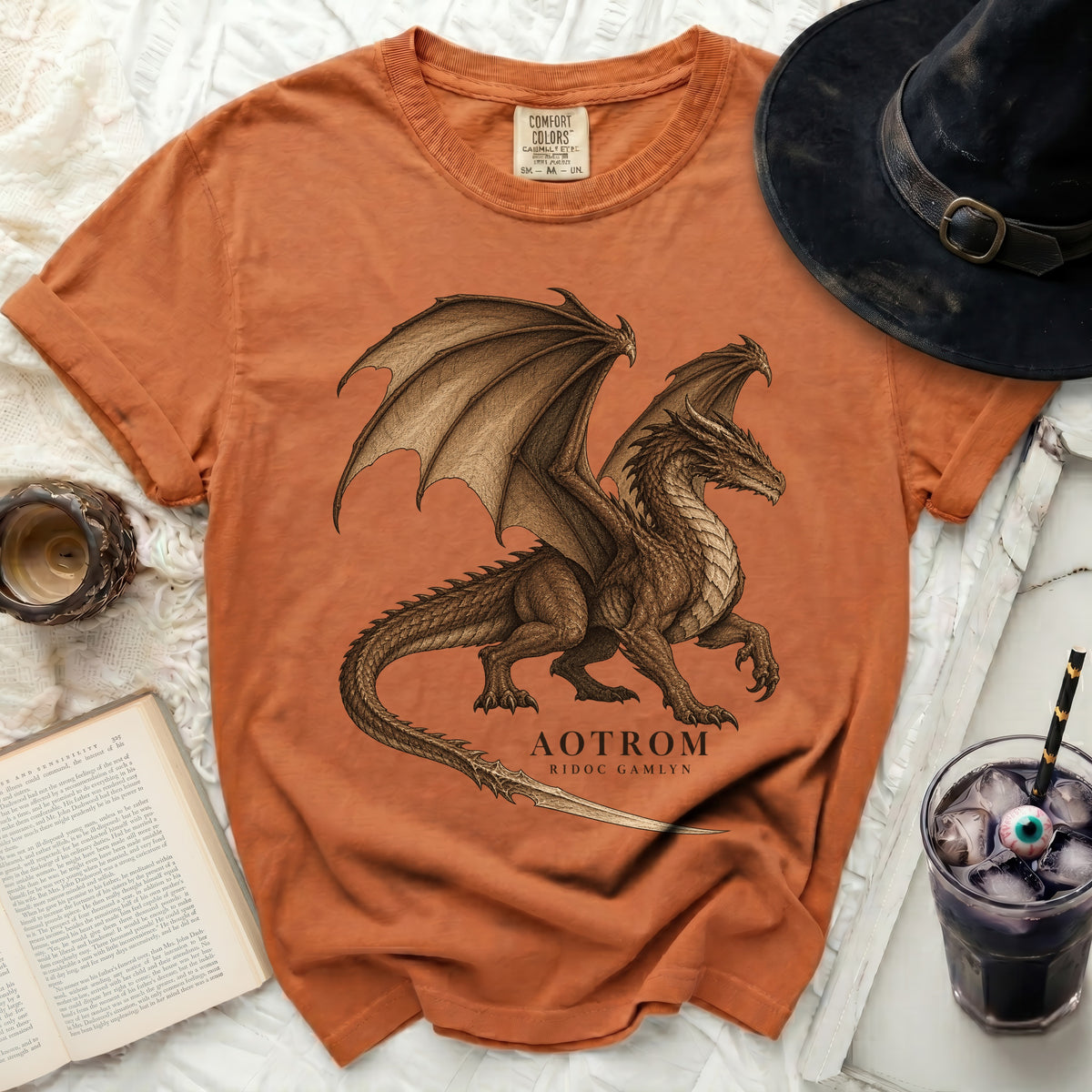 Orange t-shirt with a detailed brown dragon graphic and "AOTROM RIDOC GAMLYN" text.