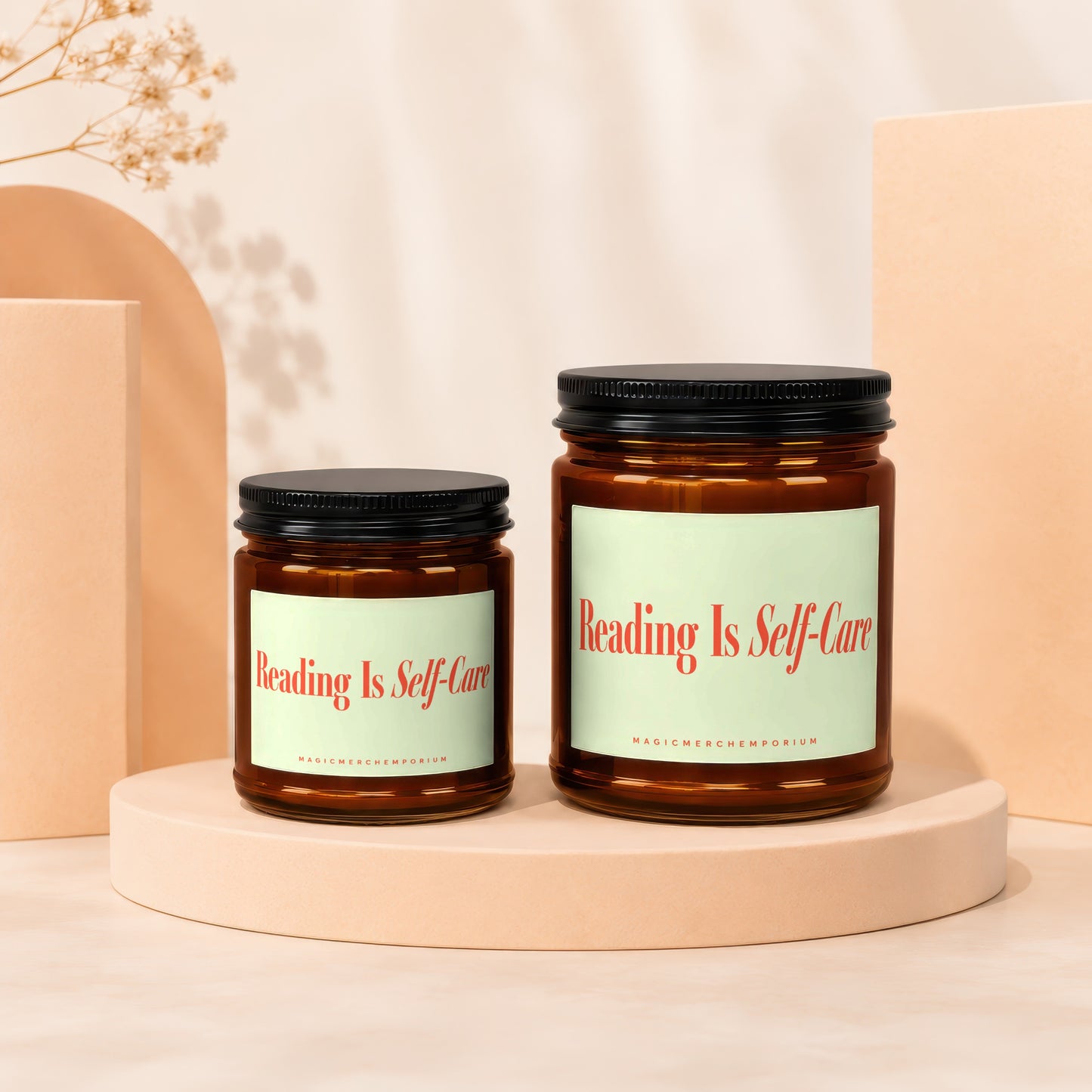 Two amber glass candles with black lids, labeled "Reading Is Self-Care."