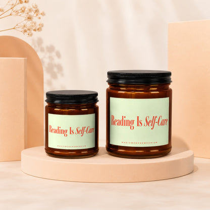 Two amber glass candles with black lids, labeled "Reading Is Self-Care."