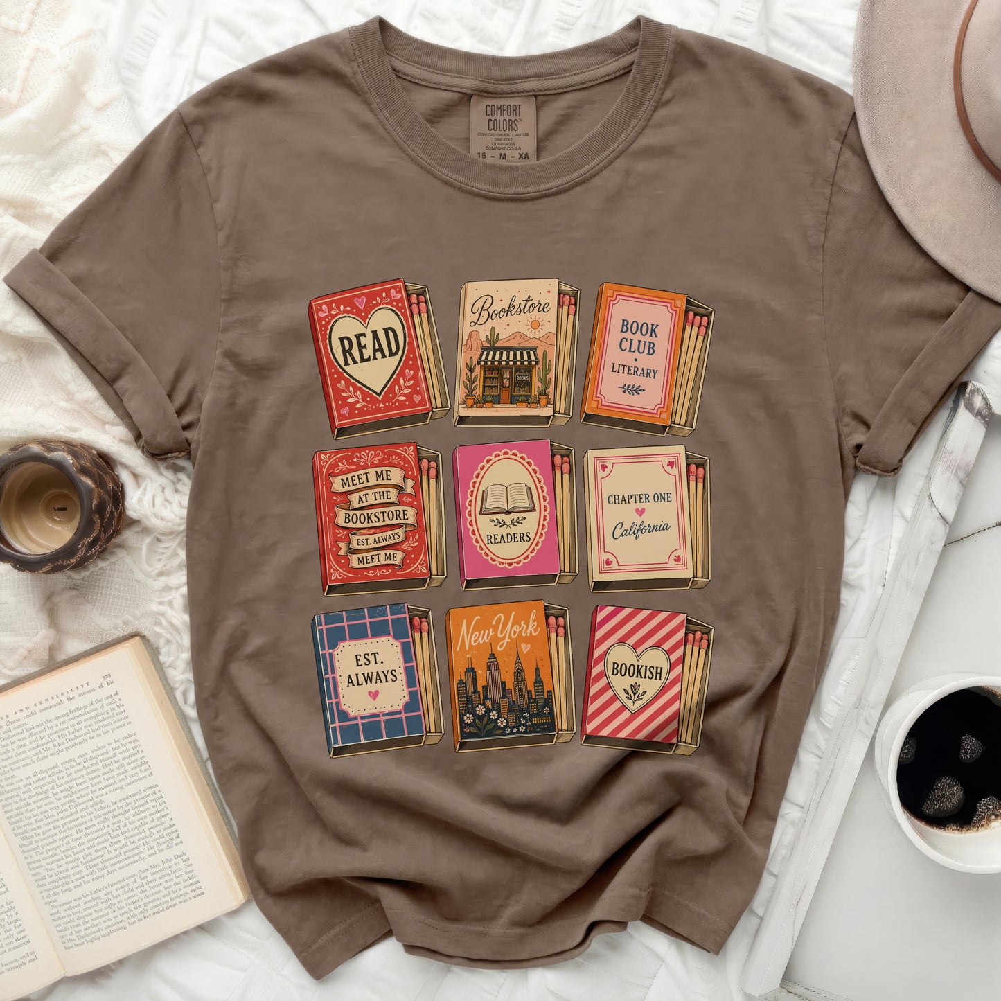 Brown t-shirt with nine colorful book-themed matchboxes and text.