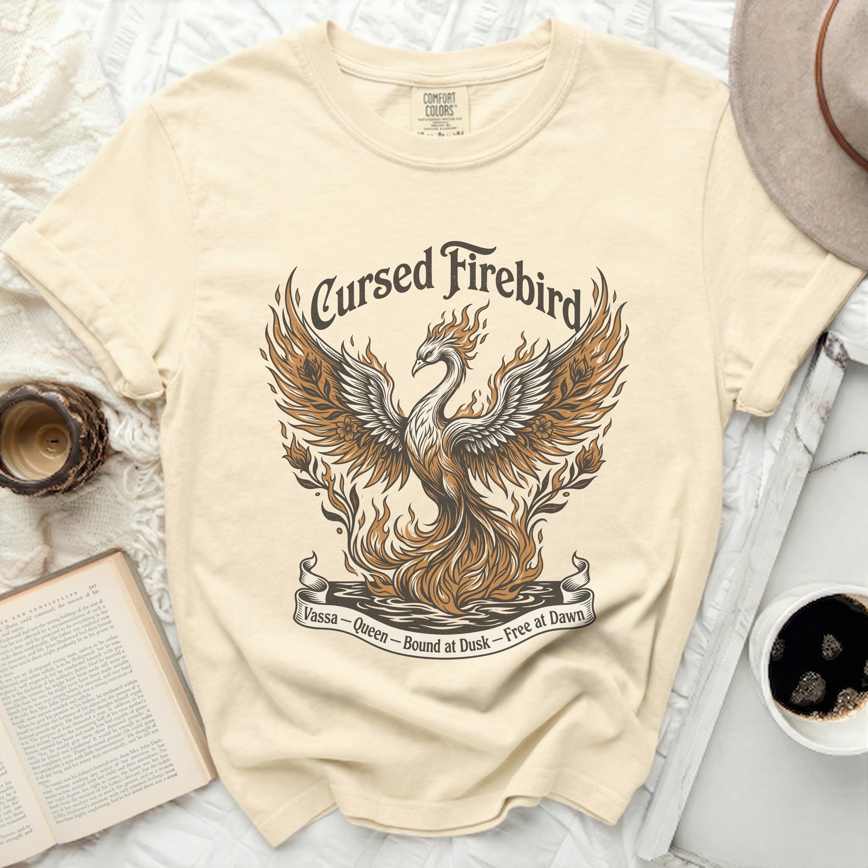 Cream t-shirt with a fiery phoenix graphic and text.