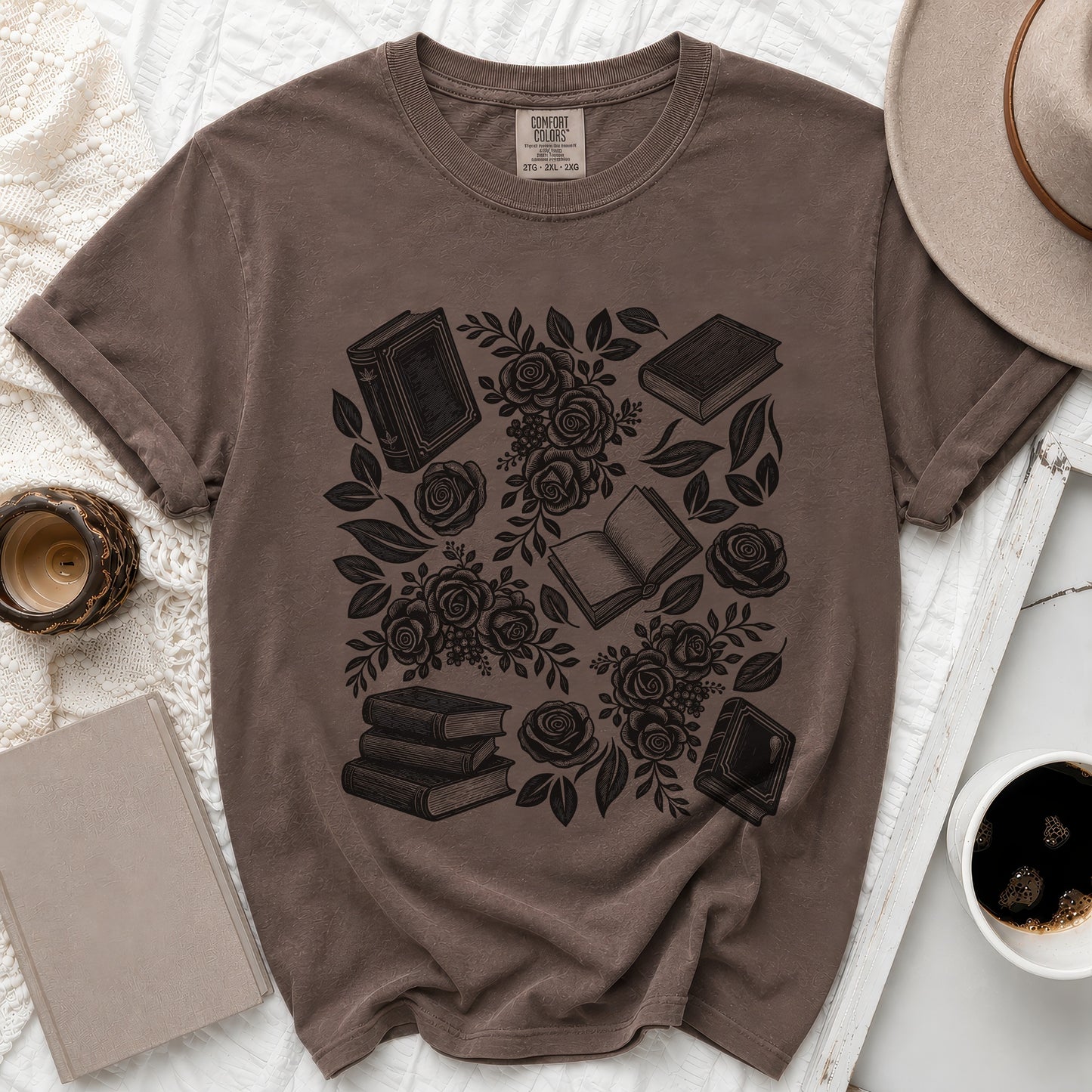 Brown t-shirt with black print of books and roses, size 2XL.