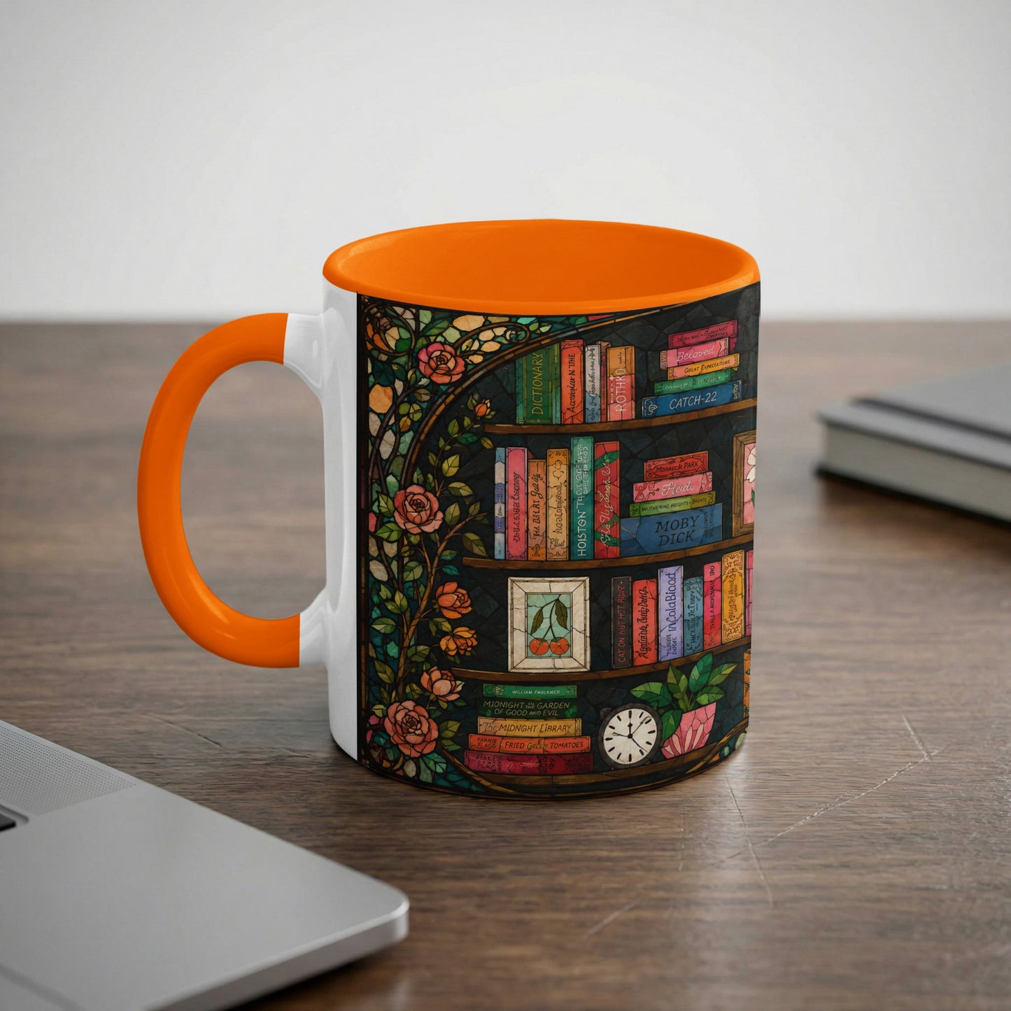 White mug with orange handle, decorated with stained glass books and roses.