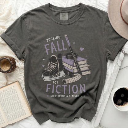 Dark grey t-shirt with "Pucking Fall Fiction" graphic and hockey imagery.