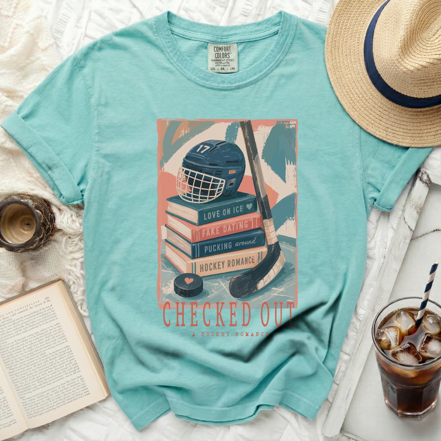 Aqua t-shirt with stacked books, hockey helmet, and "Checked Out" text.