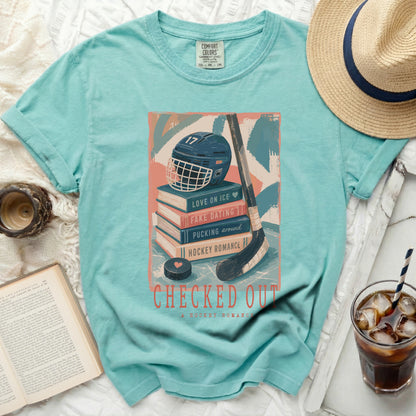 Aqua t-shirt with stacked books, hockey helmet, and "Checked Out" text.