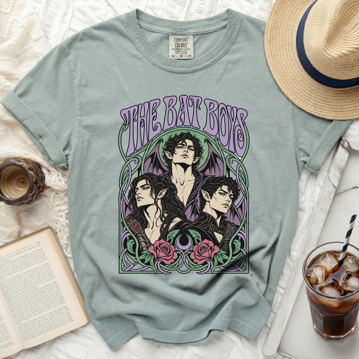 Light blue t-shirt with "THE BAT BOYS" text and three male figures with wings.