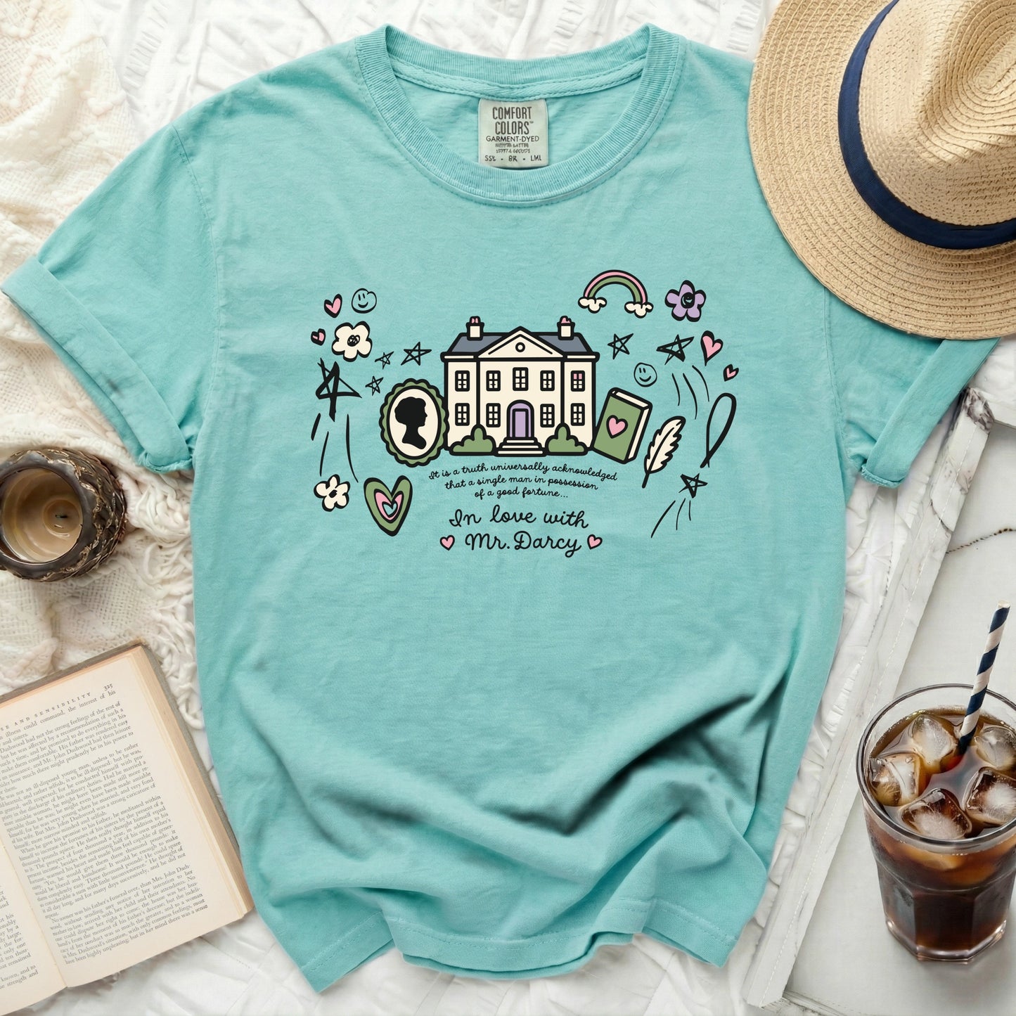 Teal graphic t-shirt with "In love with Mr. Darcy" and illustrated house.