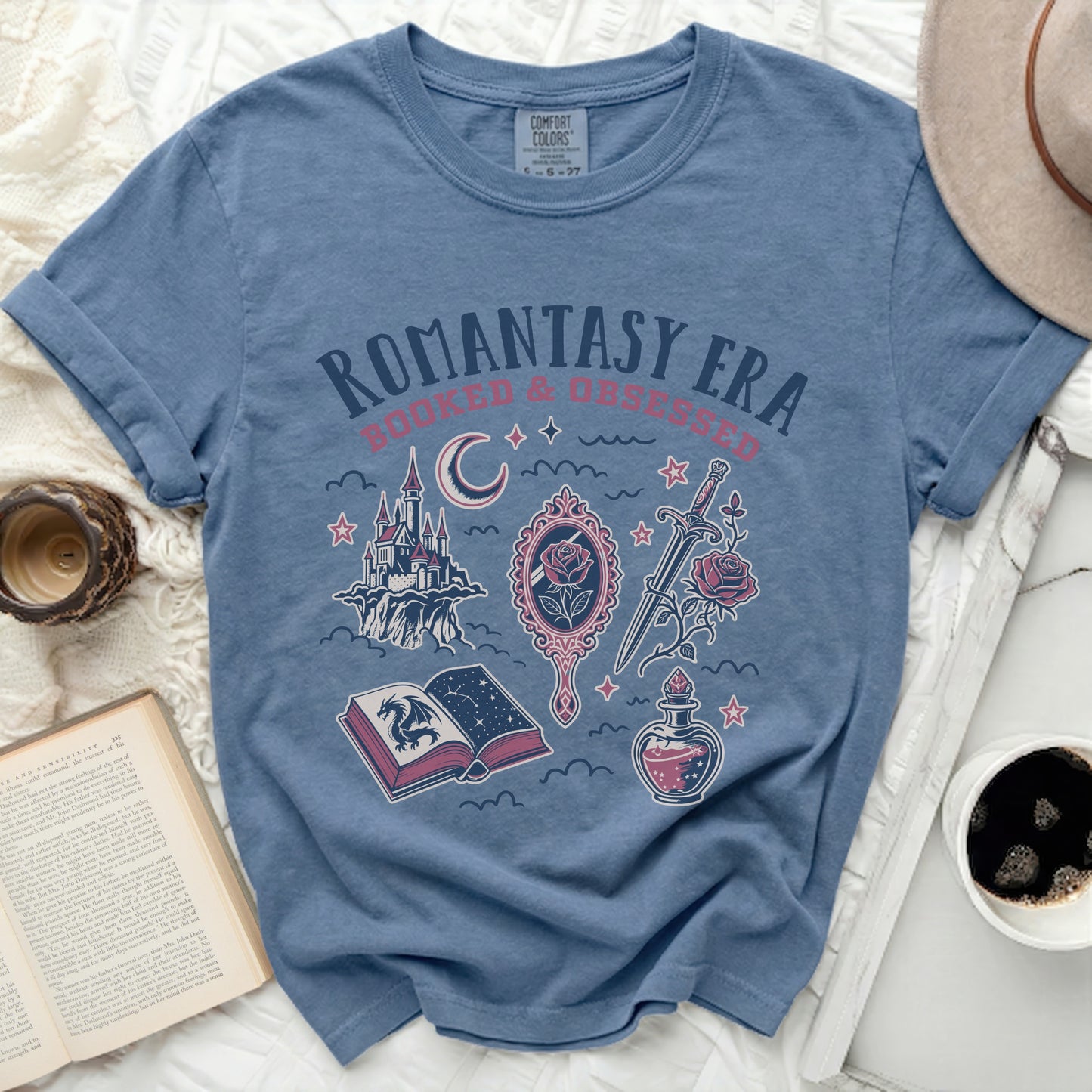 Romantasy Era t-shirt with castles, dragons, swords, and potion graphic.