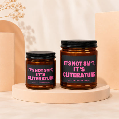Two amber candles with black lids, featuring pink text: It's Not Sm*t, It's ClITERATURE.