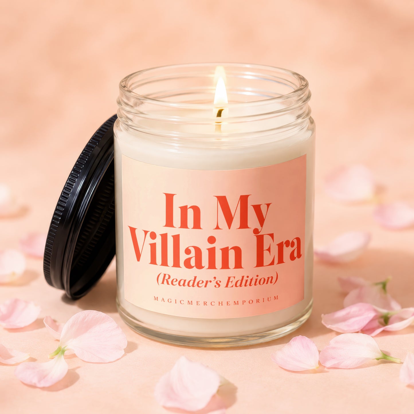 Lit glass candle with "In My Villain Era (Reader's Edition)" text and "MagicMerchEmporium" logo.