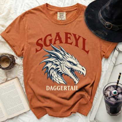 Orange t-shirt with "SGAEYL DAGGERTAIL" text and dragon graphic.