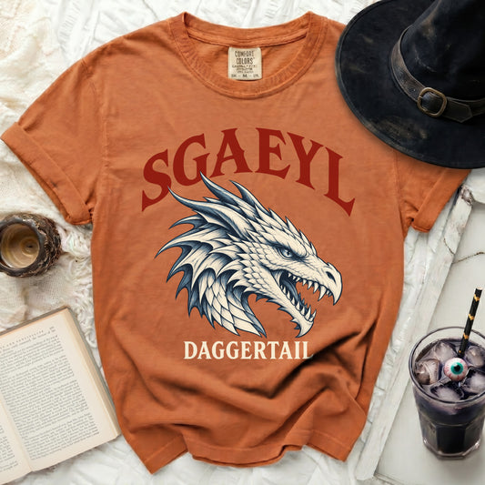 Orange t-shirt with "SGAEYL DAGGERTAIL" text and dragon graphic.