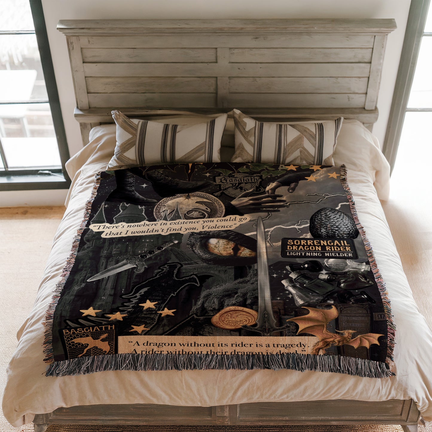a bed with a black and gold throw blanket that has various dragon-related imagery and text on it.