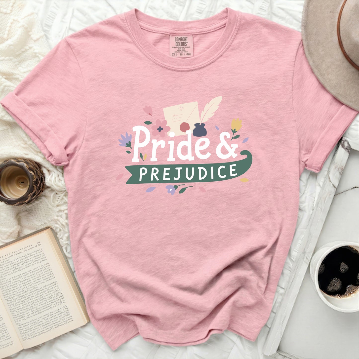 Pink t-shirt with "Pride & Prejudice" graphic and floral accents.