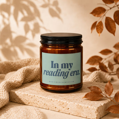 Amber jar candle with light blue label reading "In my reading era."