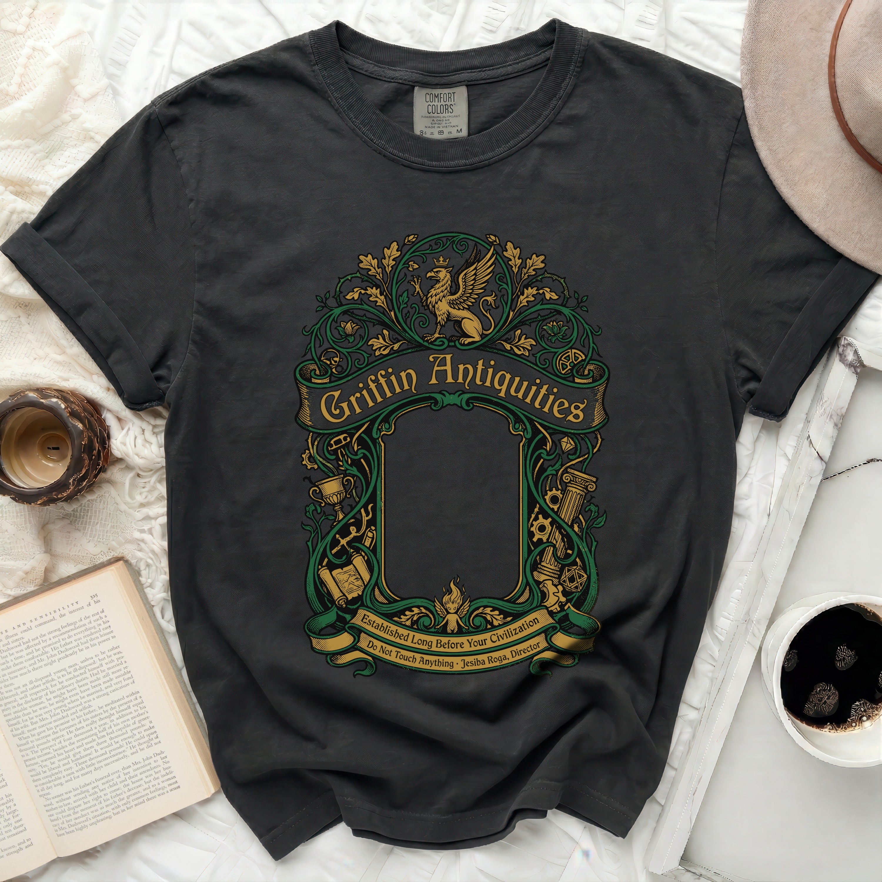 Dark grey t-shirt with green Griffin Antiquities and ornate border graphic.