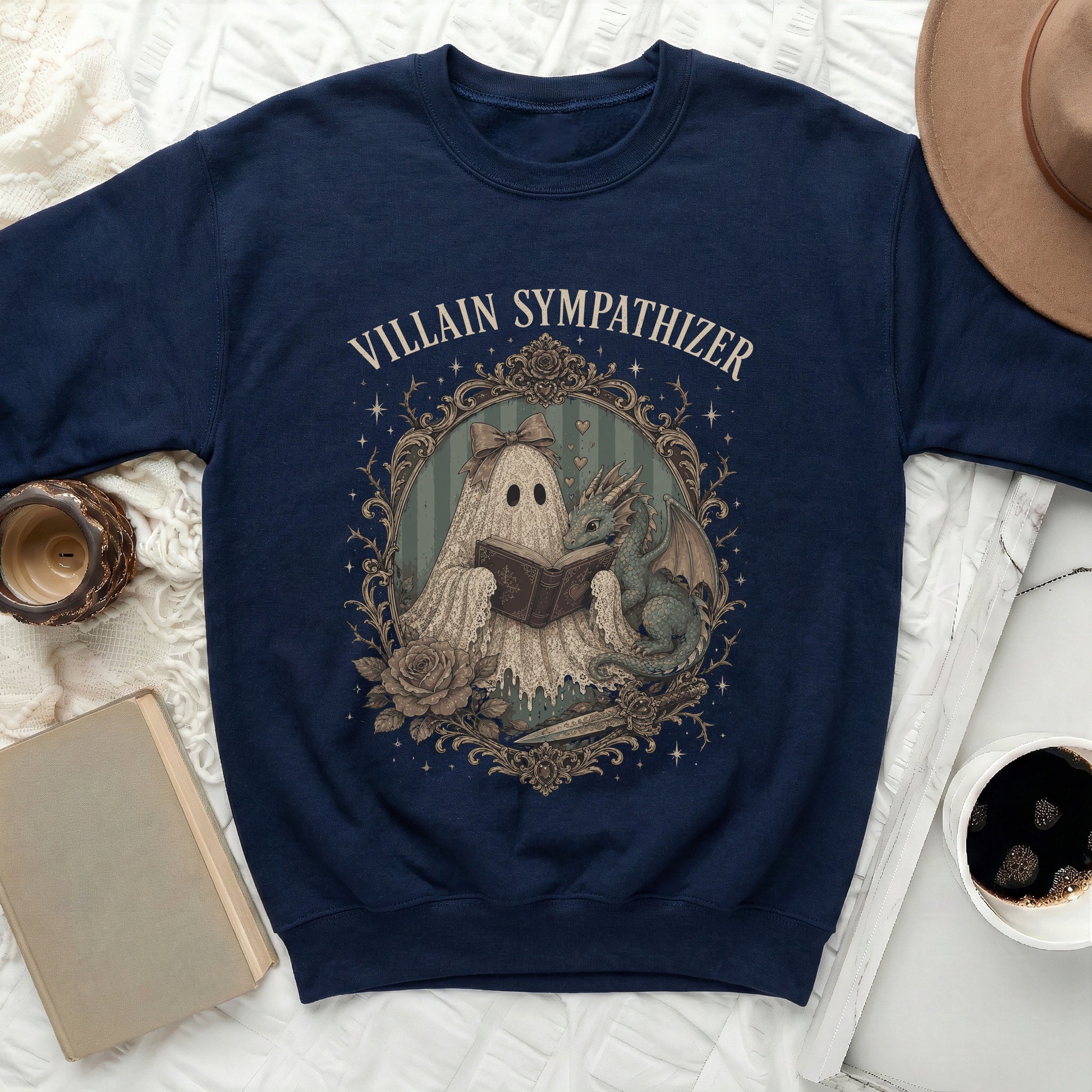 Navy sweatshirt with "Villain Sympathizer" text and a ghost reading with a dragon.