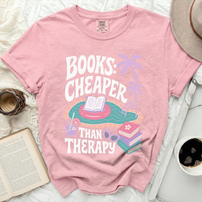 Pink t-shirt with "Books: Cheaper Than Therapy" text and swimming pool graphic.