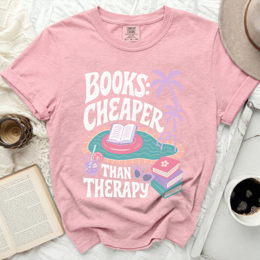 Pink t-shirt with "Books: Cheaper Than Therapy" text and swimming pool graphic.