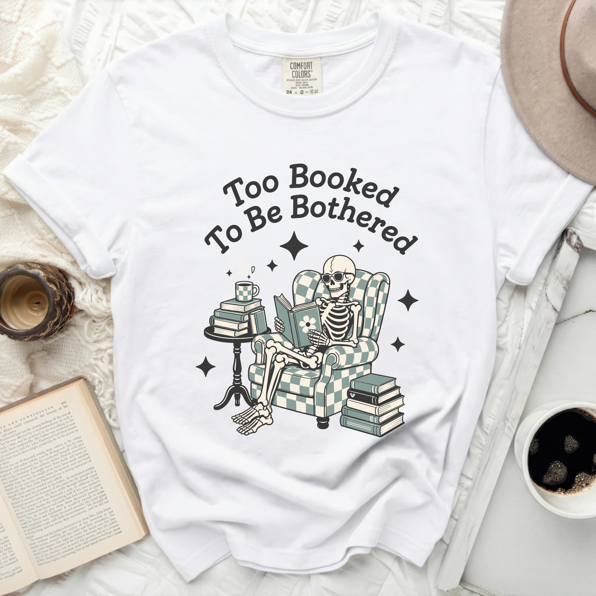 Skeleton reading a book with text "Too Booked To Be Bothered".