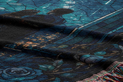 a close-up view of a textured fabric with a floral pattern, including a rose design. The fabric appears to be a dark-colored material with a blue and green color scheme.