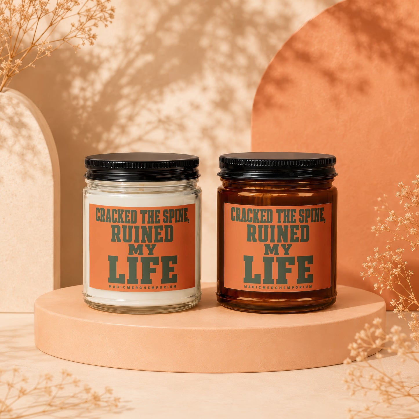 Two candles with "Cracked The Spine, Ruined My Life" text on orange labels.