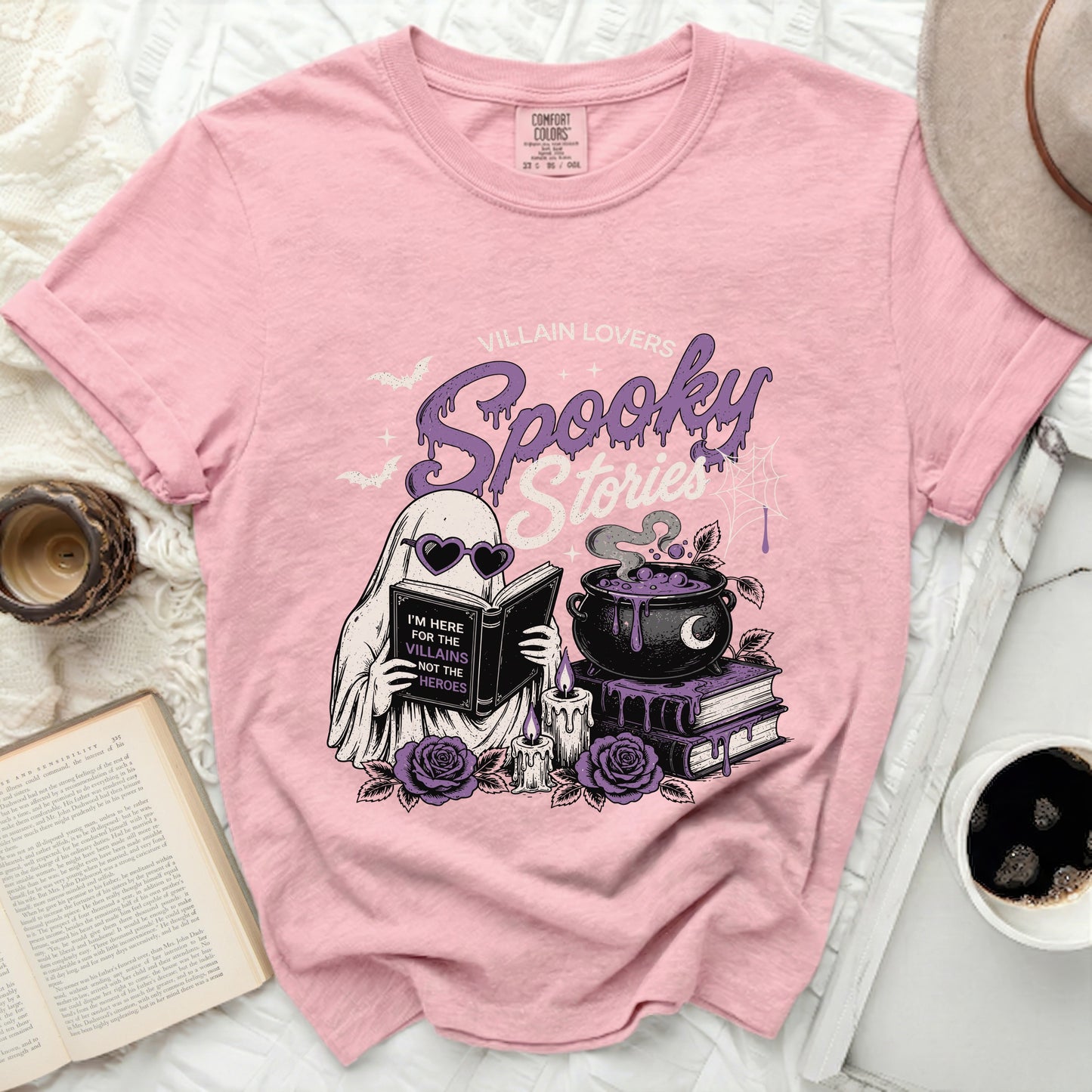 Pink t-shirt with "Villain Lovers Spooky Stories" ghost graphic and text.