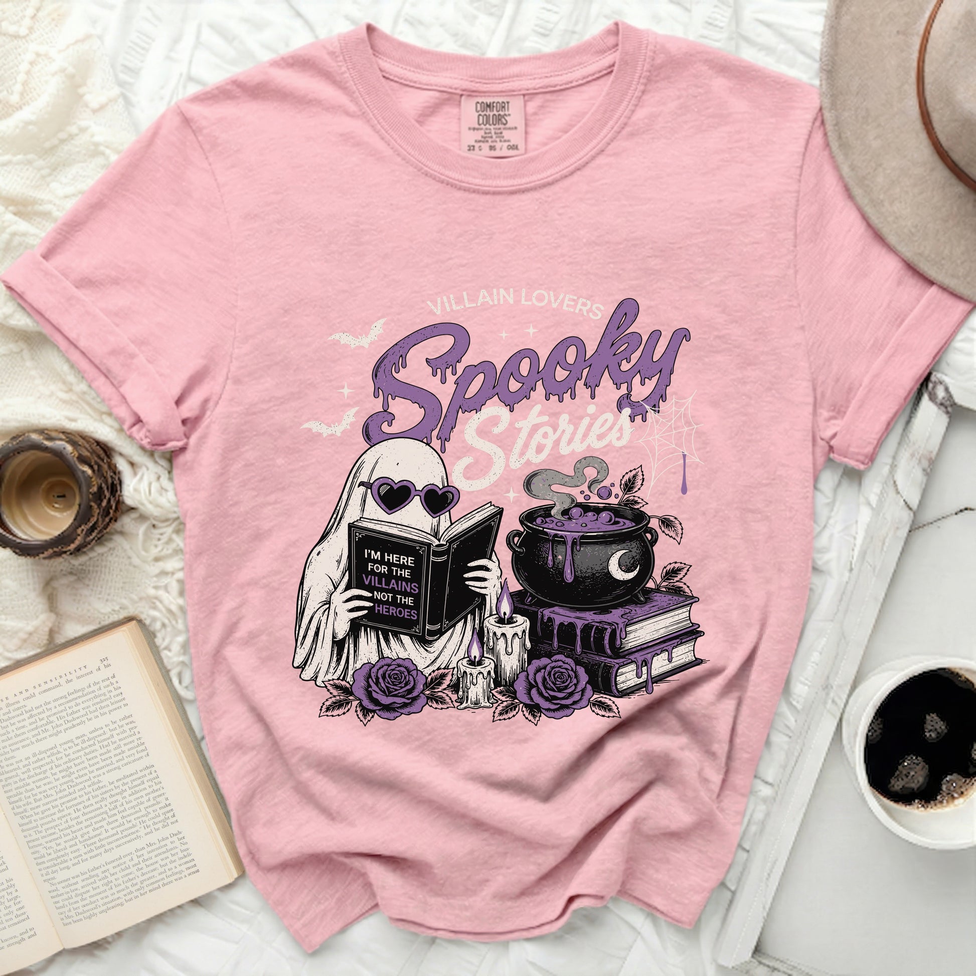 Pink t-shirt with "Villain Lovers Spooky Stories" ghost graphic and text.