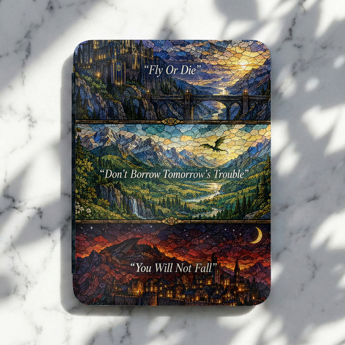 Kindle cover featuring three stained-glass style panels with fantasy landscapes and inspirational quotes.