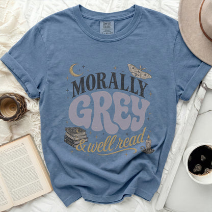 Blue t-shirt with "Morally Grey & Well Read" graphic, books, moon, moth, and candle.