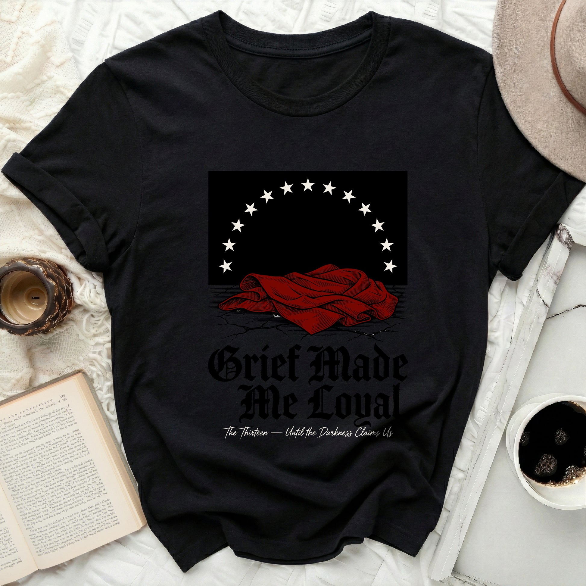 Black t-shirt with "Grief Made Me Loyal" and starry crown graphic.