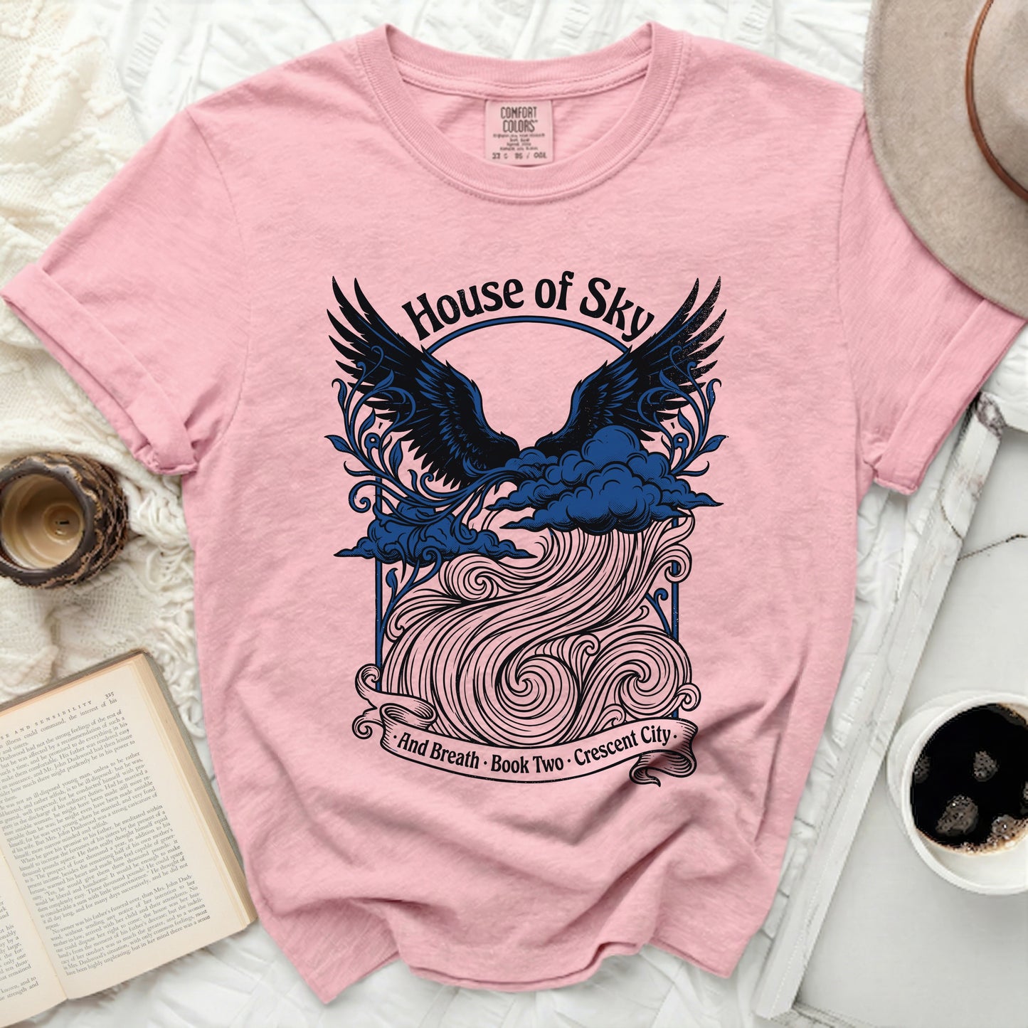 Pink t-shirt with "House of Sky and Breath" book two graphic.
