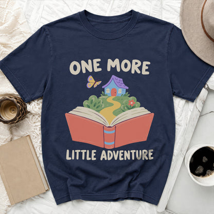 Navy t-shirt with "ONE MORE LITTLE ADVENTURE" text and book illustration.
