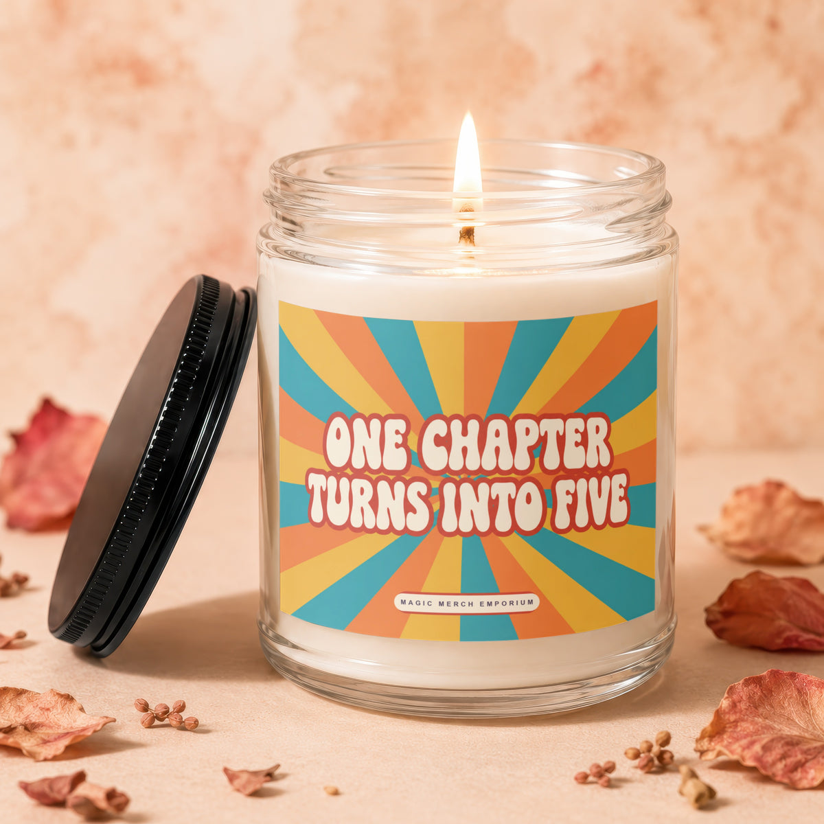 Candle with "One Chapter Turns Into Five" text on sunburst label.