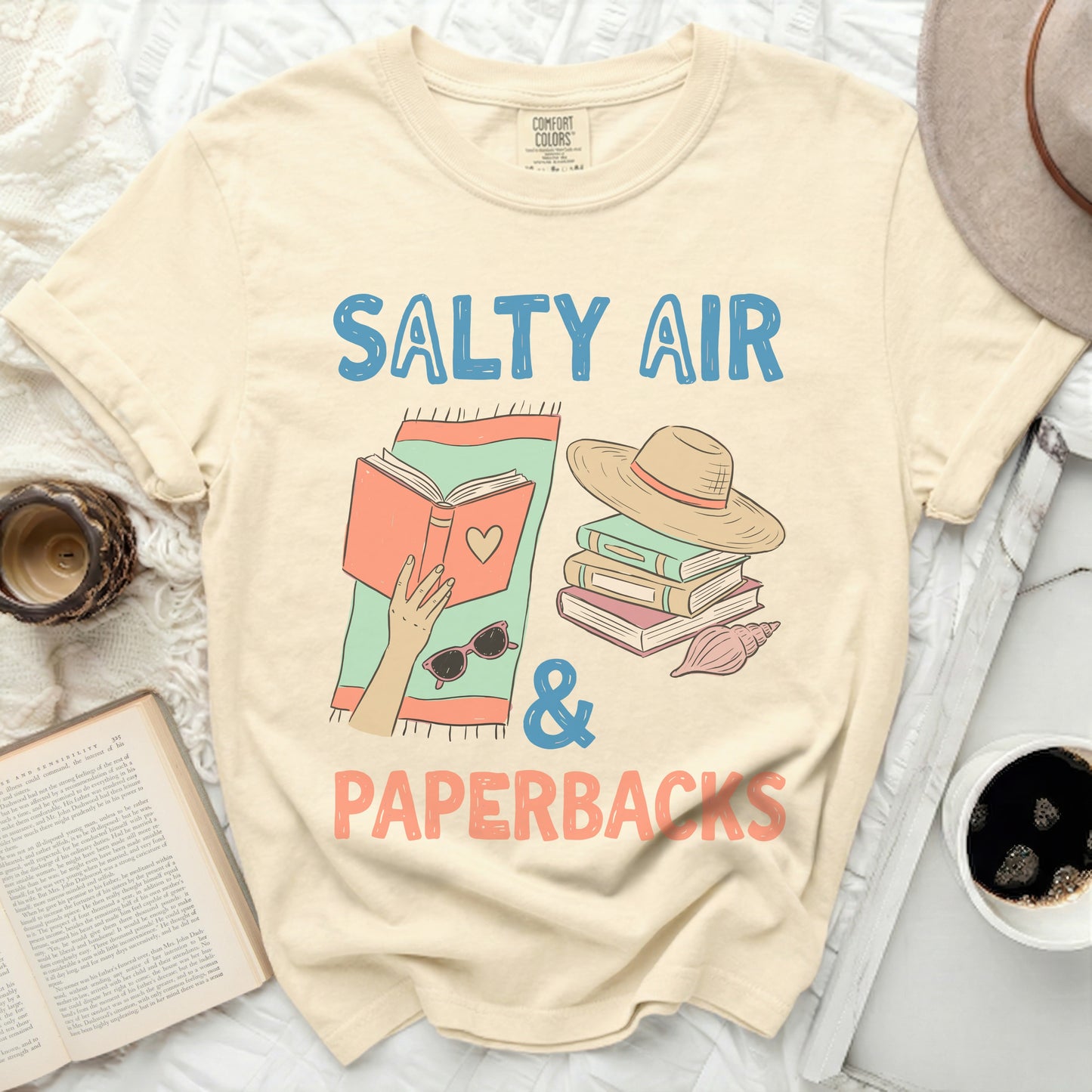 T-shirt with "Salty Air & Paperbacks" text and book illustration.