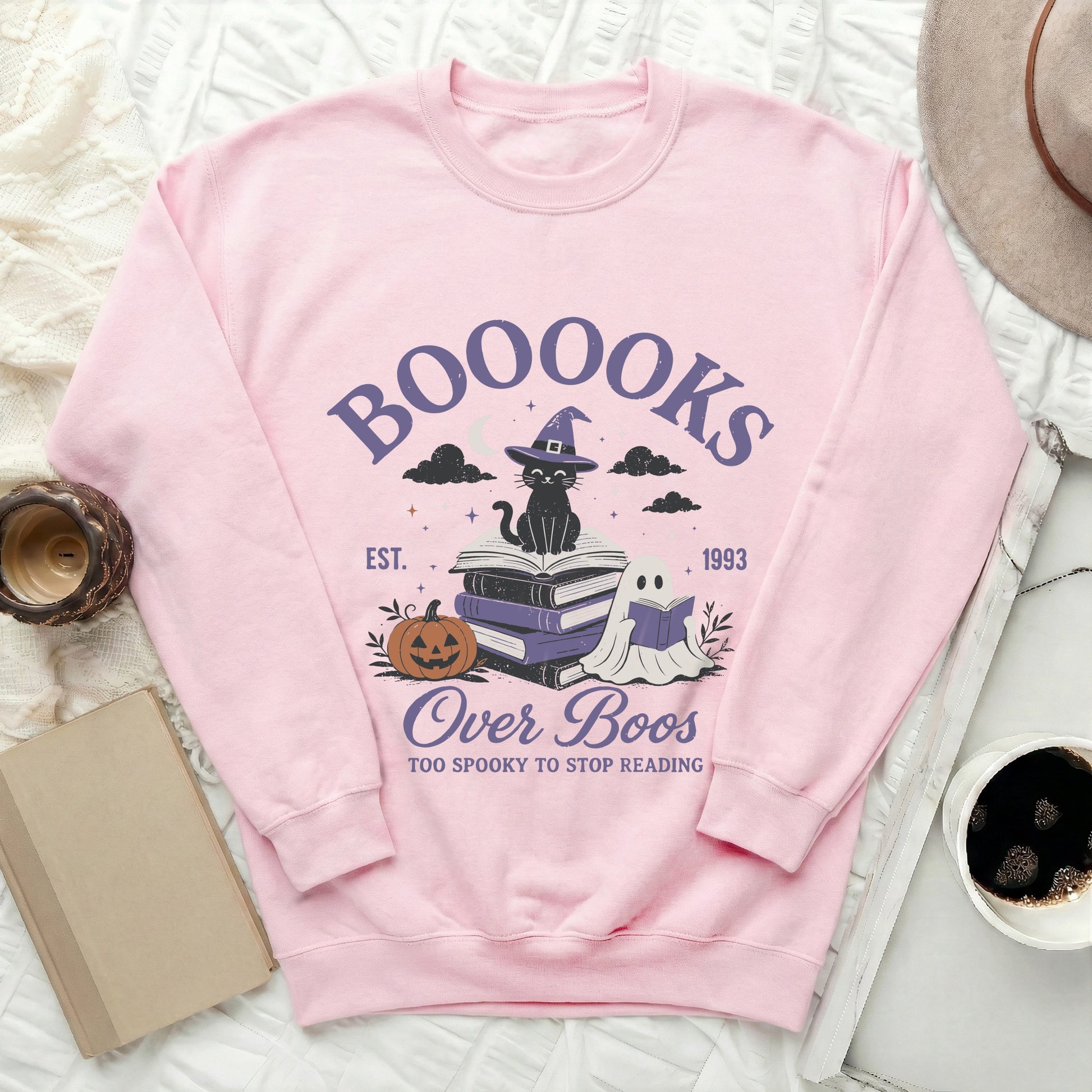Pink bodysuit with "Booooks" text, cat, pumpkin, and ghost graphic.
