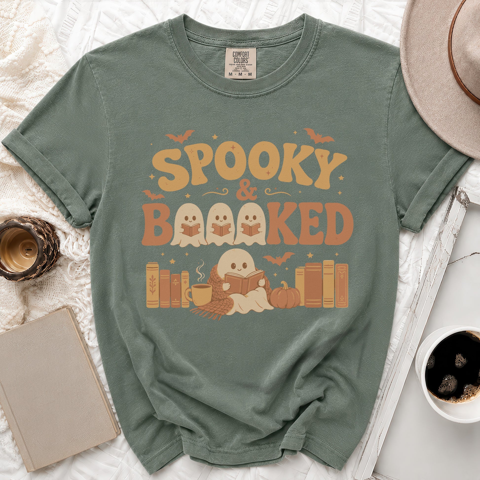 Sage green t-shirt with "Spooky & Booked" design featuring ghosts and books.