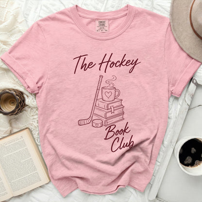Pink t-shirt with "The Hockey Book Club" text and hockey stick graphic.